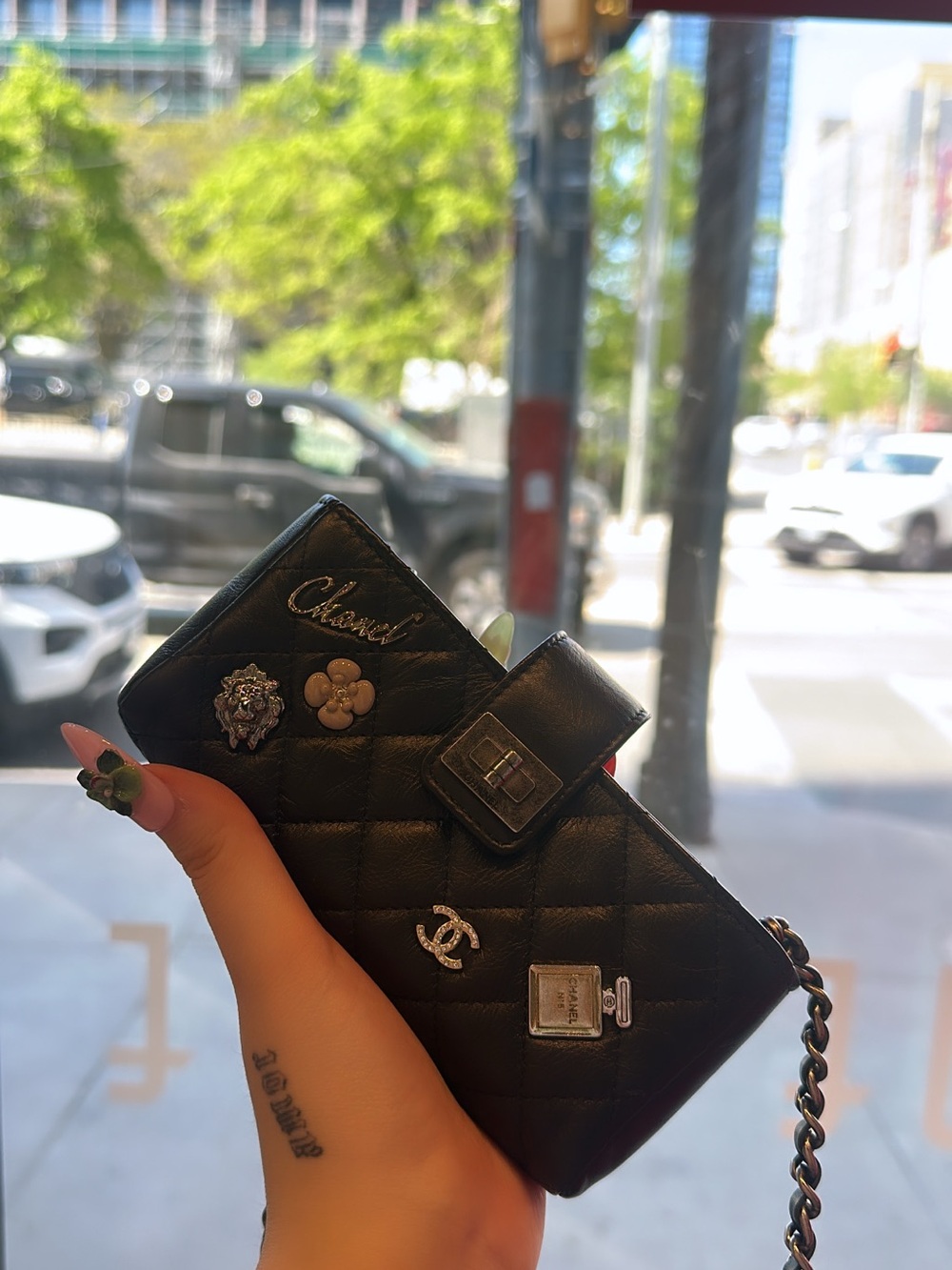 CHANEL Black Quilted Chain Wallet with Charm Accents